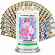 Cherry Blossom Cash Money Candle with two lit wicks and a fan of cash