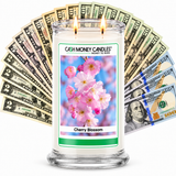 Cherry Blossom Cash Money Candle with two lit wicks and a fan of cash