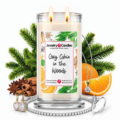 Cozy Cabin in the Woods Jewelry Candle with two lit flames and jewelry
