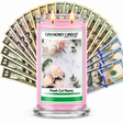 Fresh Cut Peony Cash Money Candle with two lit wicks and a fan of cash