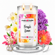 Fresh Linen Jewelry Candle with two lit flames and jewelry