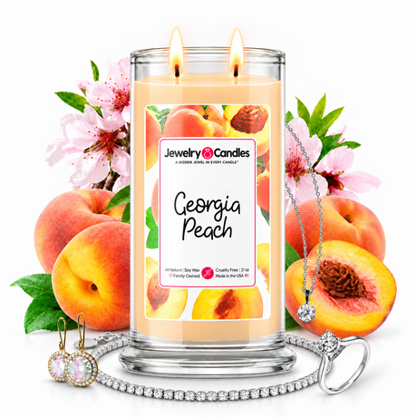 Georgia Peach Jewelry Candle with two lit flames and jewelry