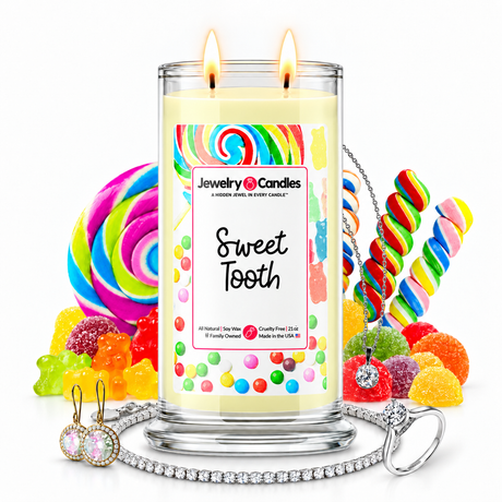 Sweet Tooth Jewelry Candle with two lit flames and jewelry